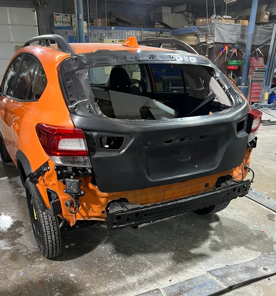 Orange Subaru before repair